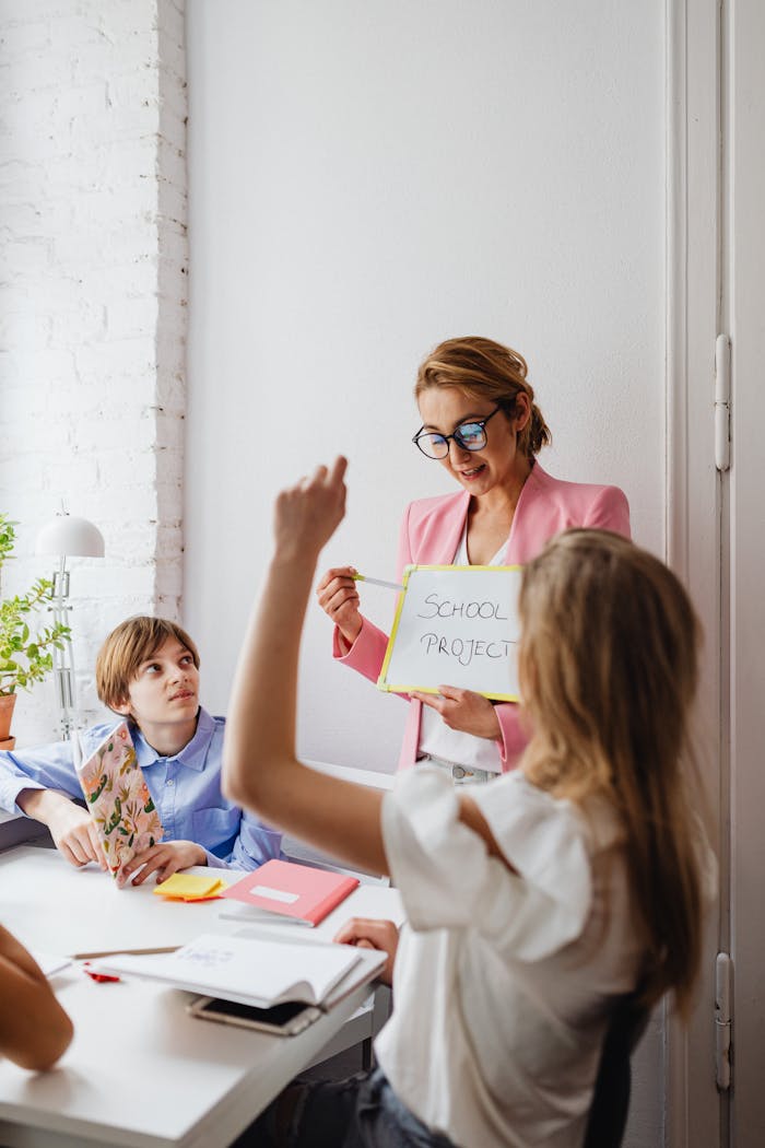 Teacher guiding students in a lively classroom with a focused learning atmosphere.